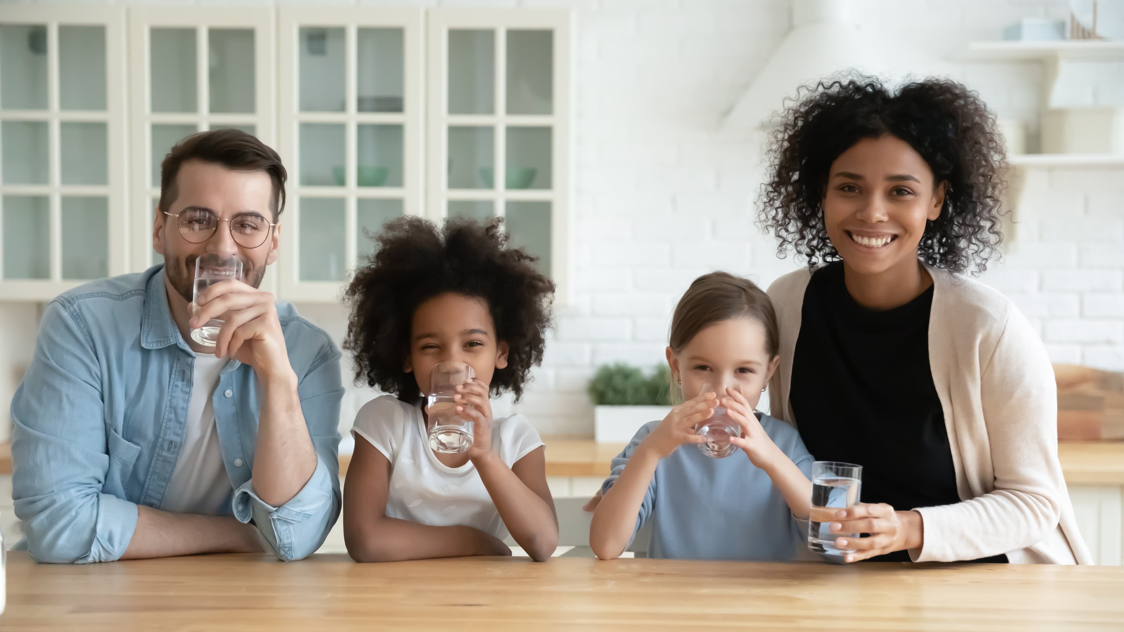 SFV family drinking filtered water at the kitchen counter